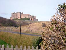 View of Bamburgh Castle from garden at 6 Armstrong Cottages, self-catering cottage in Bamburgh  Village, Northumberland, UK